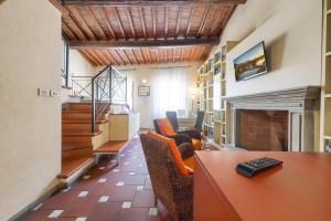 a living room with a table and a fireplace at Home Boutique Santa Maria Novella in Florence
