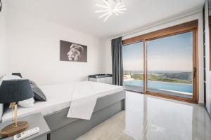 a bedroom with a desk and a large window at Vila katune 2022 in Ulcinj +10 photos
