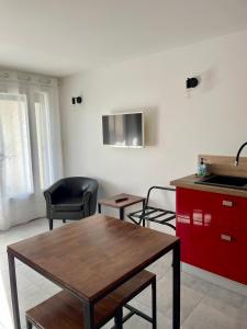 eine Küche mit einem Holztisch und einer Arbeitsplatte in der Unterkunft Maison d'hôtes Romarine in Le Bouscat