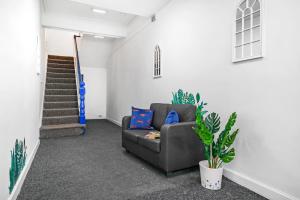 a living room with a couch and stairs at Sunshine Serviced Apartments by Happy Sunshine Stay in Goole