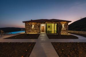 a villa with a pathway leading to a building at Vila katune 2022 in Ulcinj