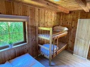 A bed or beds in a room at Domki Pod Lasem