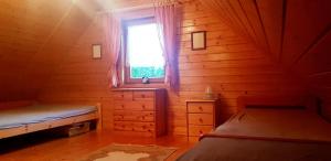 a small room with two beds and a window at Szyszka i Róża Domek na Jurze in Zelasko +26 photos