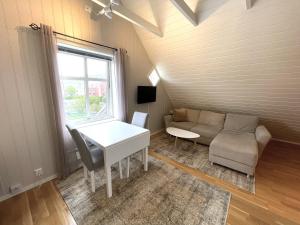 a living room with a couch and a table at Presttind - Studio apartment with free parking in Narvik