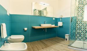 a blue bathroom with a toilet and a sink at ANNICRU' AFFITTACAMERE in Castellammare del Golfo