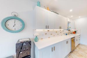 a kitchen with a clock hanging on the wall at Brooks Lake House in Christina +22 photos