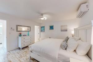 a white bedroom with a white bed and a dresser at Brooks Lake House in Christina