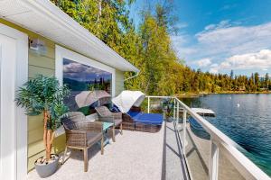 a balcony of a house with chairs and a table at Brooks Lake House in Christina
