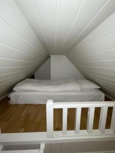 a bed in a loft with a white bed frame at Presttind - Studio apartment with free parking in Narvik