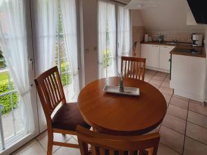 a kitchen and dining room with a wooden table and chairs at Apartments, Mirow in Mirow