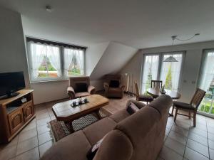 a living room with a couch and a table at Apartments, Mirow in Mirow