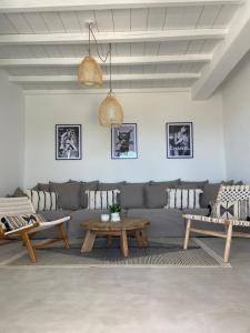 a living room with a couch and a table at Sun House Paros in Kampos Paros