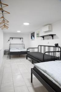 a room with three beds and a tile floor at Apartma Licko in Domžale