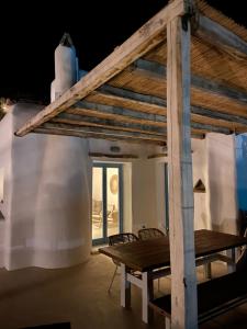 a room with a wooden table and a table and chairs at Sun House Paros in Kampos Paros