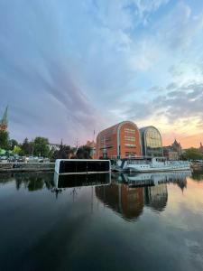 a large building sitting next to a body of water at Dom na wodzie in Bydgoszcz