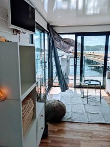 uma sala de estar com vista para o oceano em Schwimmendes Haus Johanne auf dem Wasser inkl Boot in Blankaholm em Blankaholm