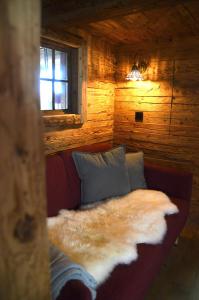 een bed in een blokhut met een pelsdeken bij Chalet Bergliebe in Brilon