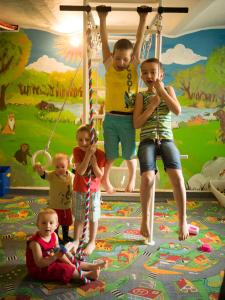 a group of children playing on a swing at Agroturystyka BRYGADZIAKI in Charbielin