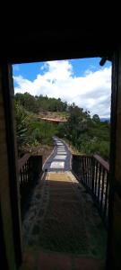 a view from a doorway of a walkway at Hacienda Mawaka in Ráquira