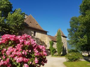 un edificio con flores rosas delante de él en Château beyrin, 