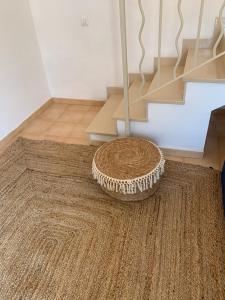 a rug on the floor in a room with a staircase at Es Cucó in Cala Galdana