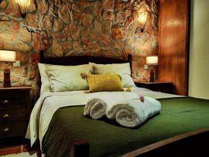 a bedroom with a bed with towels on it at Quinta do Vale Encantado "the Valley" - Santarém - Portugal in Calhariz +122 photos