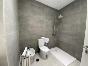 a bathroom with a toilet and a shower at Luxury Loft Apartment in Ribeira Grande +20 photos