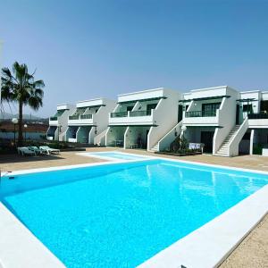 an image of a swimming pool in front of a building at Casa Luna in Puerto del Carmen