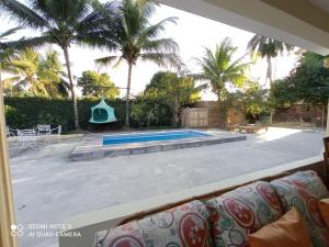 a view of a swimming pool with palm trees at Paraiso Hortensia Ecolodge in Santiago de los Caballeros