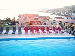 a group of chairs sitting next to a swimming pool at Kuća Pećine in Metajna