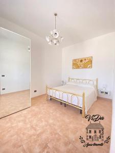 a bedroom with a bed and a mirror at ViDa Apartments casa vacanze in Frigole