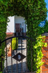 a gate to a garden with a chair on it at Pensjonat Basia in Dziwnówek