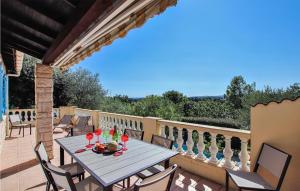 a patio with a table and chairs on a balcony at 3 Bedroom Lovely Home In Colonzelle in Colonzelle