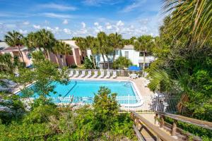 an image of a swimming pool with trees and houses at Sea Turtle Shores in St. Augustine