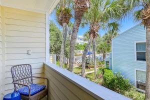 a chair sitting on a porch with palm trees at Sea Turtle Shores in St. Augustine