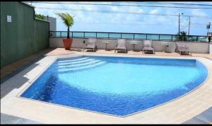 a large blue swimming pool on the roof of a building at Natal Plaza 604-Ponta Negra in Natal