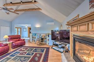 a living room with a television and a fireplace at Sleeping Bear Lake Cabin Hot Tub, Dock and Sauna! in Honor