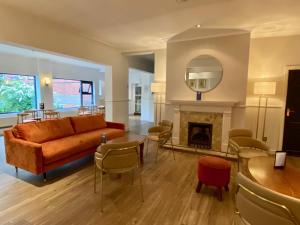 a living room with a couch and a fireplace at Birmingham Great Barr Hotel in Birmingham