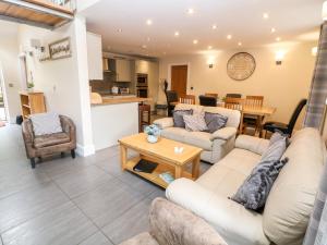 a living room with two couches and a table at 3 Pheasant Lane in Deepcar