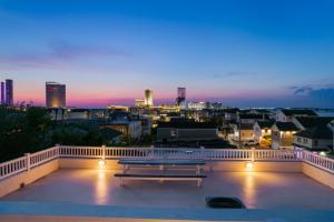 a bench on a balcony with a view of a city at ❤️ The Top End Townhomes with Stunning Views On One-Of-A-Kind Rooftop Deck! WOW! in Atlantic City