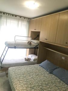 - une chambre avec 2 lits superposés et une fenêtre dans l'établissement Estate Famiglia Andora, à Marina dʼAndora