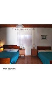 a bedroom with two beds and a window at Amaryllis sweet home in Pyrgos