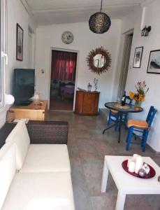 a living room with a couch and a table at Amaryllis sweet home in Pyrgos