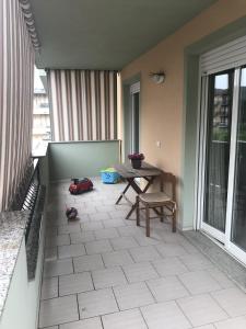 a patio with a table and chairs on a balcony at Estate Famiglia Andora in Marina dʼAndora