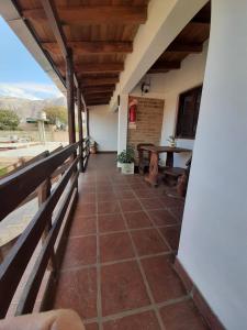 a room with a balcony with a table at Luna y Cumbres in Cafayate