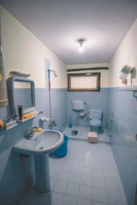 a bathroom with a sink and a toilet at Al Amin Guest House - Home away from Home in Skardu