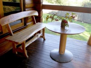 a bench and a table on a porch at Meteorits in Smiltene