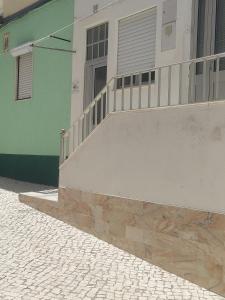 a building with a staircase next to a building at Casa da Cristina in Nazaré