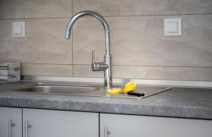 a kitchen sink with a knife and an orange on a cutting board at Exochiko Kalamitsi in Kalamitsi +83 photos