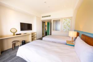 Voodi või voodid majutusasutuse Kenting Long Beach Hotel toas